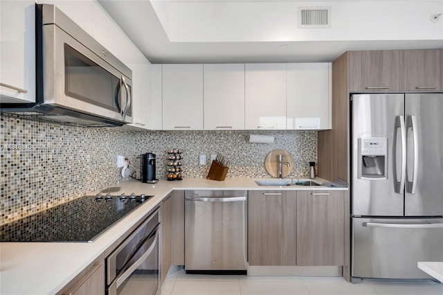 5252 NW 85th Ave Unit 1701, Doral, FL 33166 - kitchen featuring appliances with stainless steel finishes, light countertops, modern cabinets, and white cabinetry