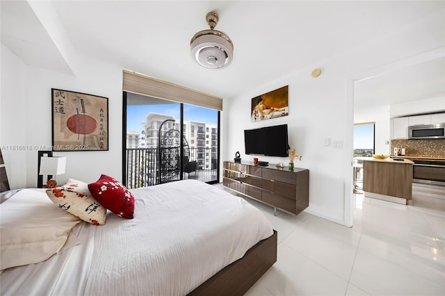 5252 NW 85th Ave Unit 1701, Doral, FL 33166 - bedroom with light tile patterned floors, access to exterior, baseboards, and a wall of windows