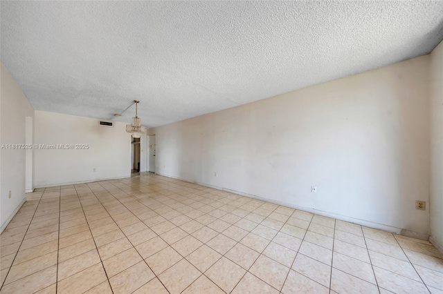 7921 Byron Ave Unit 407, Miami Beach, FL 33141 - unfurnished room featuring a textured ceiling, a chandelier, light tile patterned floors, and baseboards