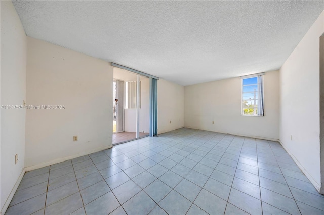 7921 Byron Ave Unit 407, Miami Beach, FL 33141 - unfurnished room featuring a textured ceiling and light tile patterned floors