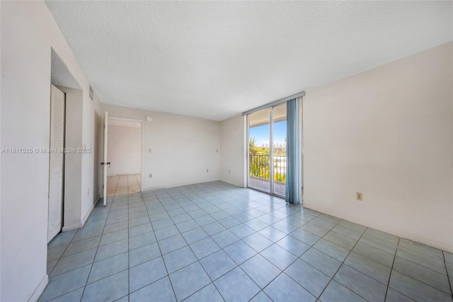 7921 Byron Ave Unit 407, Miami Beach, FL 33141 - spare room with floor to ceiling windows, a textured ceiling, and light tile patterned floors