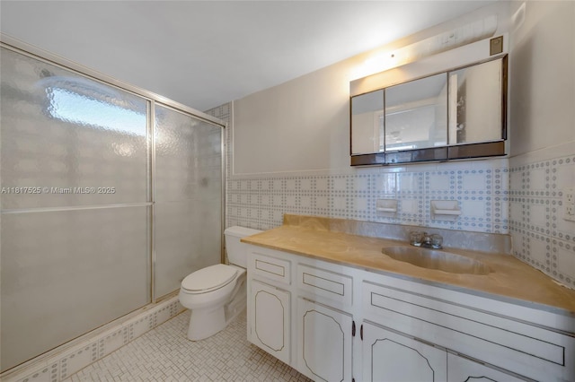 7921 Byron Ave Unit 407, Miami Beach, FL 33141 - full bath with tile walls, toilet, a shower stall, vanity, and tile patterned floors
