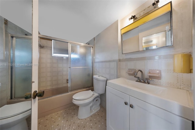 7921 Byron Ave Unit 407, Miami Beach, FL 33141 - full bathroom with toilet, enclosed tub / shower combo, vanity, tile patterned flooring, and tile walls