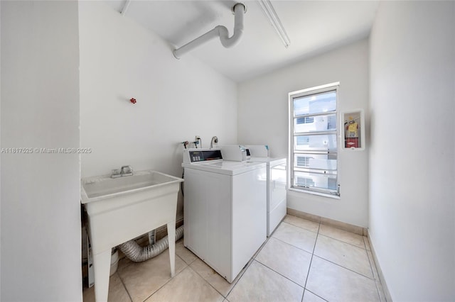 7921 Byron Ave Unit 407, Miami Beach, FL 33141 - laundry area featuring a sink, washing machine and clothes dryer, and light tile patterned floors
