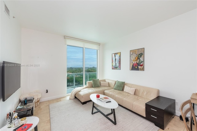 2525 SW 3rd Ave Unit 711, Miami, FL 33129 - tiled living room featuring a wall of windows and baseboards