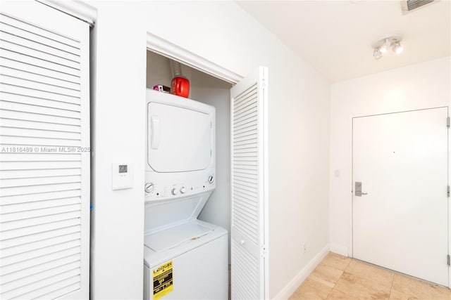 2525 SW 3rd Ave Unit 711, Miami, FL 33129 - laundry area with stacked washer / drying machine and baseboards