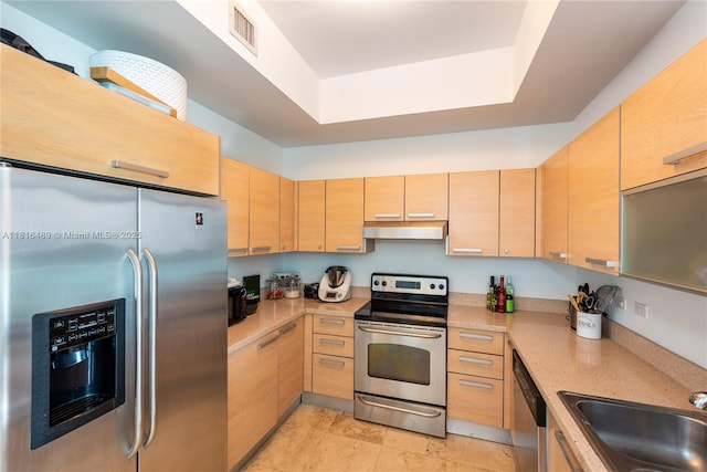 2525 SW 3rd Ave Unit 711, Miami, FL 33129 - kitchen featuring stainless steel appliances, under cabinet range hood, light brown cabinetry, a raised ceiling, and a sink
