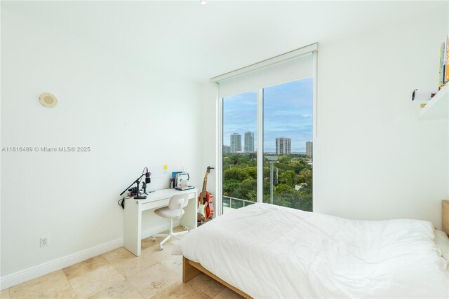 2525 SW 3rd Ave Unit 711, Miami, FL 33129 - bedroom with baseboards, a desk, and a view of city