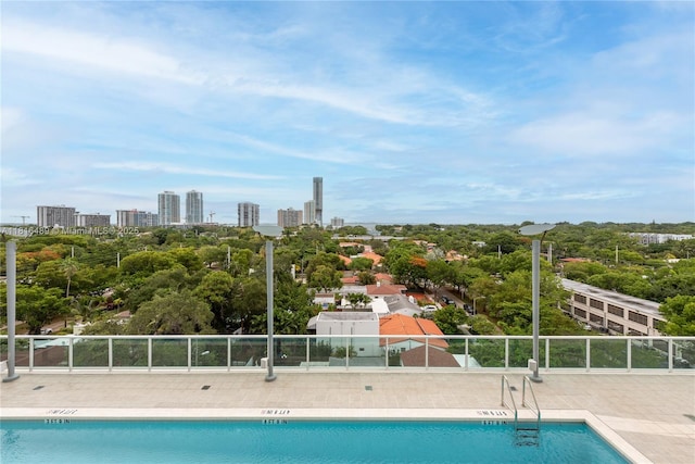 2525 SW 3rd Ave Unit 711, Miami, FL 33129 - community pool featuring view of wooded area, a patio area, and a view of city