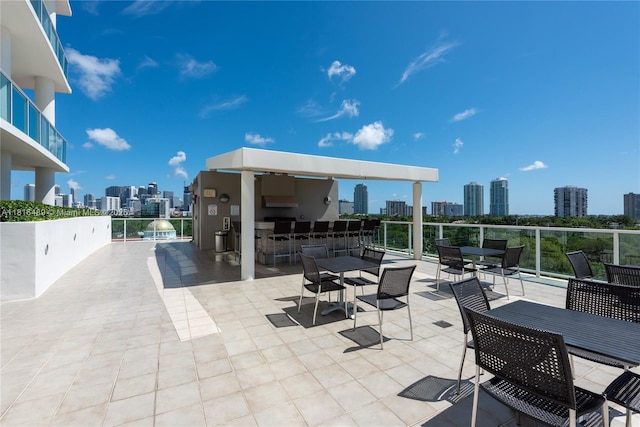2525 SW 3rd Ave Unit 711, Miami, FL 33129 - view of patio / terrace with a view of skyline, exterior kitchen, outdoor dining space, and exterior bar