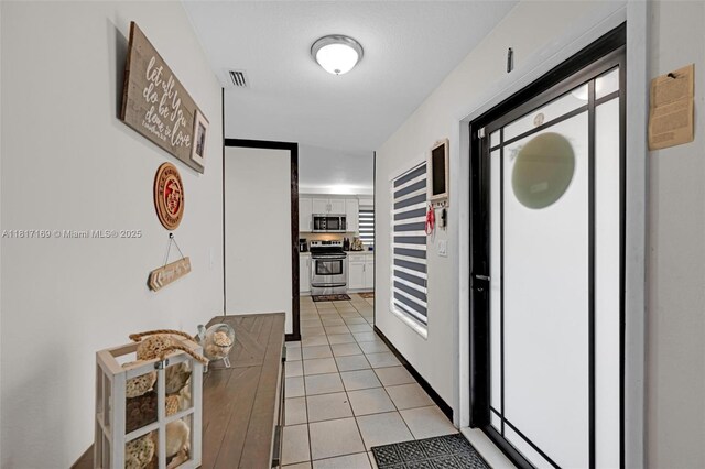 30930 SW 190th Ave, Homestead, FL 33030 - hallway featuring light tile patterned flooring and healthy amount of natural light