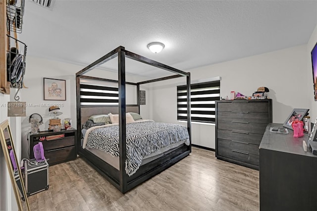 30930 SW 190th Ave, Homestead, FL 33030 - bedroom featuring light wood-type flooring and a textured ceiling