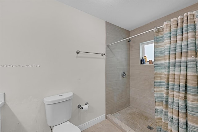 30930 SW 190th Ave, Homestead, FL 33030 - bathroom with tiled shower, toilet, tile patterned flooring, and baseboards