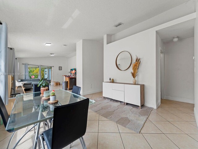 14358 SW 175th Ter, Miami, FL 33177 - dining room featuring light tile patterned floors, a textured ceiling, and baseboards