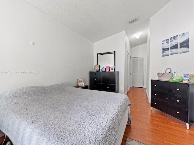 14358 SW 175th Ter, Miami, FL 33177 - bedroom featuring wood finished floors, lofted ceiling, and a textured ceiling
