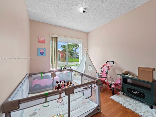 14358 SW 175th Ter, Miami, FL 33177 - playroom featuring wood finished floors and a textured ceiling