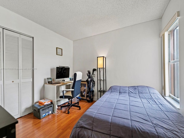14358 SW 175th Ter, Miami, FL 33177 - bedroom with wood finished floors, a textured ceiling, a closet, and an office area