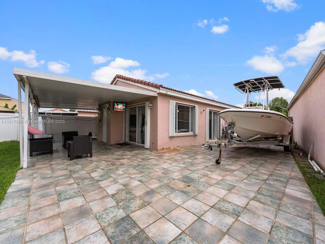 14358 SW 175th Ter, Miami, FL 33177 - rear view of house with a tile roof, stucco siding, and a patio