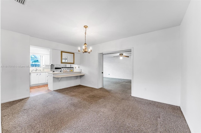 9401 SW 78th St, Miami, FL 33173 - kitchen featuring light carpet, a chandelier, white cabinetry, a peninsula, and ceiling fan