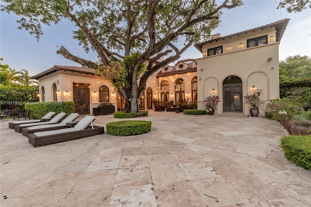 9801 SW 60th Ct, Pinecrest, FL 33156 - view of front of property featuring french doors, a patio, and stucco siding