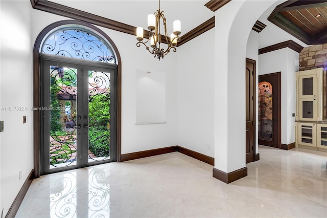 9801 SW 60th Ct, Pinecrest, FL 33156 - entryway featuring arched walkways, a chandelier, french doors, baseboards, and crown molding
