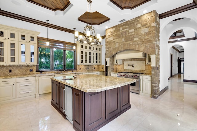 9801 SW 60th Ct, Pinecrest, FL 33156 - kitchen featuring designer stove, coffered ceiling, arched walkways, backsplash, and crown molding