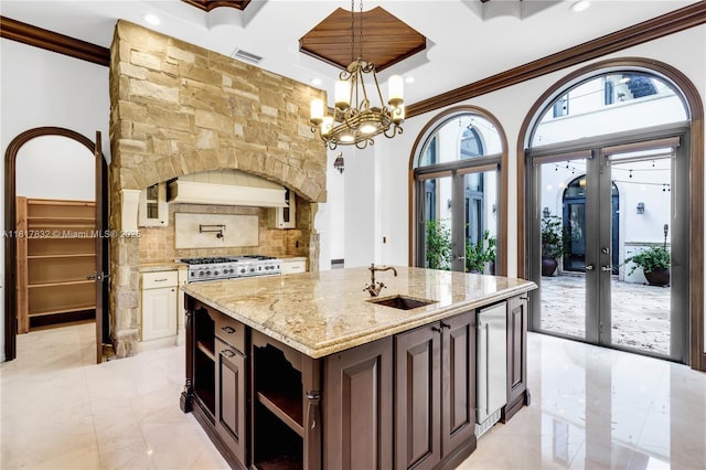 9801 SW 60th Ct, Pinecrest, FL 33156 - kitchen featuring a sink, crown molding, light stone countertops, coffered ceiling, and beverage cooler