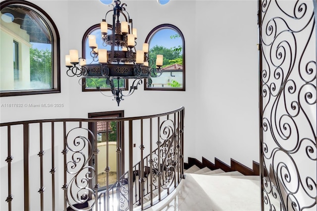 9801 SW 60th Ct, Pinecrest, FL 33156 - staircase featuring a chandelier and plenty of natural light