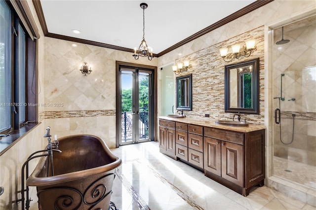 9801 SW 60th Ct, Pinecrest, FL 33156 - bathroom with a shower stall, a freestanding bath, double vanity, ornamental molding, and a chandelier