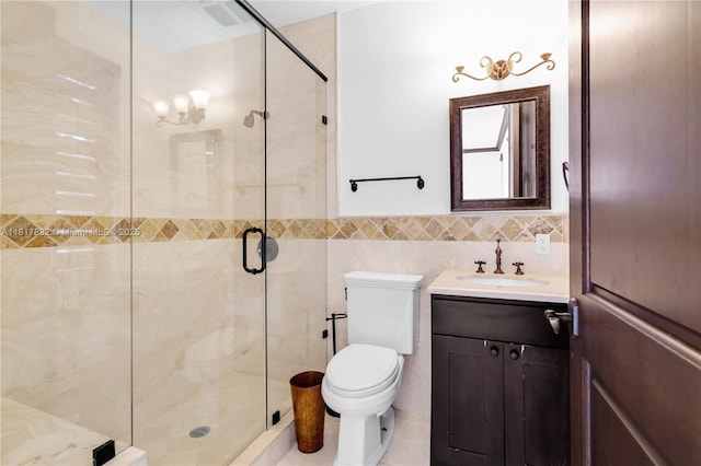 9801 SW 60th Ct, Pinecrest, FL 33156 - bathroom featuring vanity, a stall shower, toilet, tile walls, and wainscoting