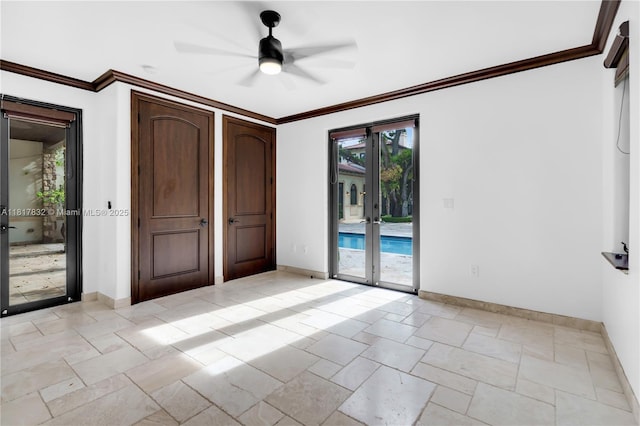 9801 SW 60th Ct, Pinecrest, FL 33156 - spare room with baseboards, stone tile flooring, a ceiling fan, french doors, and crown molding