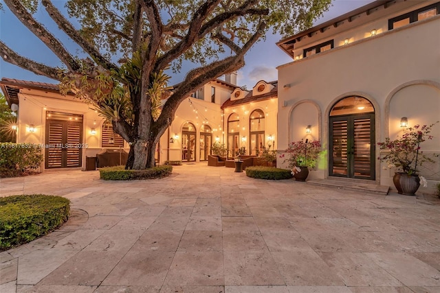 9801 SW 60th Ct, Pinecrest, FL 33156 - view of patio featuring french doors and an outdoor hangout area