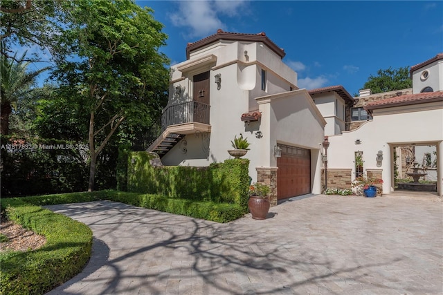 9801 SW 60th Ct, Pinecrest, FL 33156 - mediterranean / spanish home featuring driveway, a garage, and stucco siding