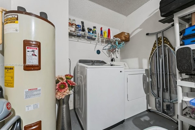 11045 SW 16th Mnr, Davie, FL 33324 - laundry room featuring electric water heater, washing machine and clothes dryer, and a textured ceiling