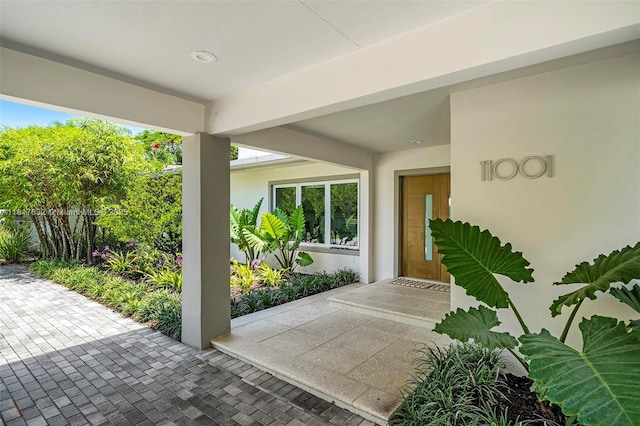 11001 SW 64th Ave, Pinecrest, FL 33156 - doorway to property with stucco siding and a patio area