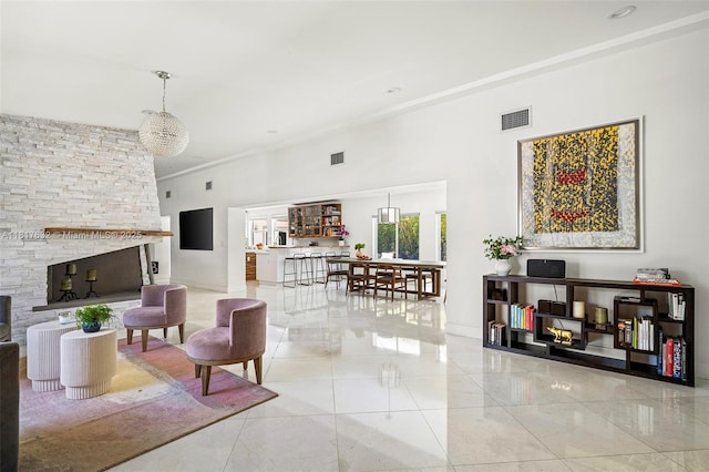 11001 SW 64th Ave, Pinecrest, FL 33156 - tiled living area with a towering ceiling, a fireplace, and ornamental molding