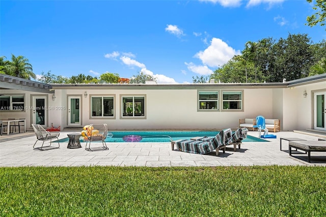 11001 SW 64th Ave, Pinecrest, FL 33156 - rear view of property featuring a patio area, stucco siding, and a yard