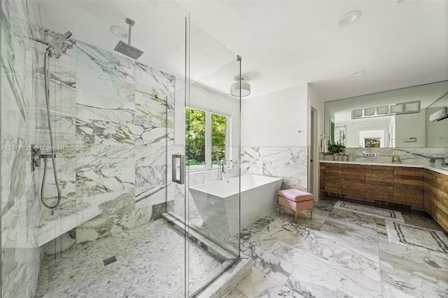 11001 SW 64th Ave, Pinecrest, FL 33156 - bathroom with a marble finish shower, a freestanding bath, vanity, tile walls, and a wainscoted wall