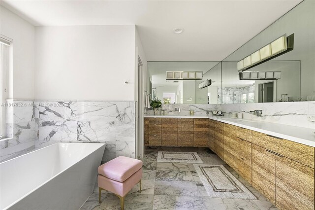 11001 SW 64th Ave, Pinecrest, FL 33156 - full bath featuring a freestanding bath, double vanity, marble tiled flooring, wainscoting, and tile walls