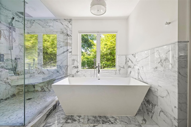 11001 SW 64th Ave, Pinecrest, FL 33156 - bathroom featuring tile walls, marble tiled flooring, a marble finish shower, a freestanding tub, and a wainscoted wall
