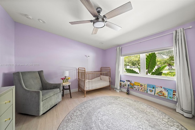 11001 SW 64th Ave, Pinecrest, FL 33156 - bedroom featuring light wood-type flooring, a nursery area, and ceiling fan