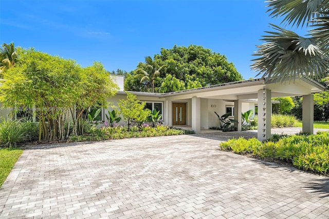 11001 SW 64th Ave, Pinecrest, FL 33156 - view of front of property featuring decorative driveway, stucco siding, and a carport