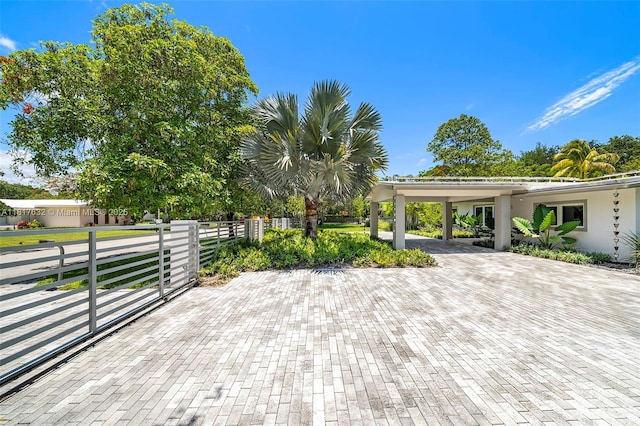 11001 SW 64th Ave, Pinecrest, FL 33156 - view of patio / terrace with decorative driveway and a carport