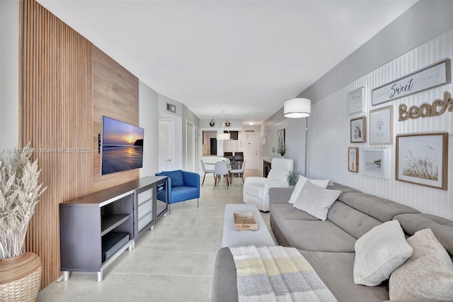300 Golden Isles Dr Unit 204, Hallandale Beach, FL 33009 - living room featuring light tile patterned floors and wooden walls