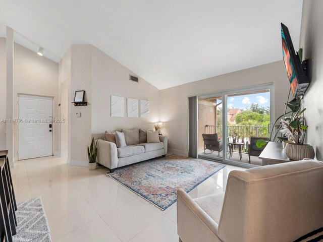 10421 SW 157th Pl Unit 301, Miami, FL 33196 - living room with high vaulted ceiling, baseboards, and light tile patterned flooring