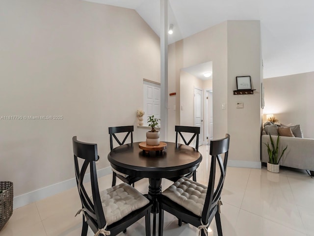 10421 SW 157th Pl Unit 301, Miami, FL 33196 - dining area with high vaulted ceiling, light tile patterned flooring, and baseboards