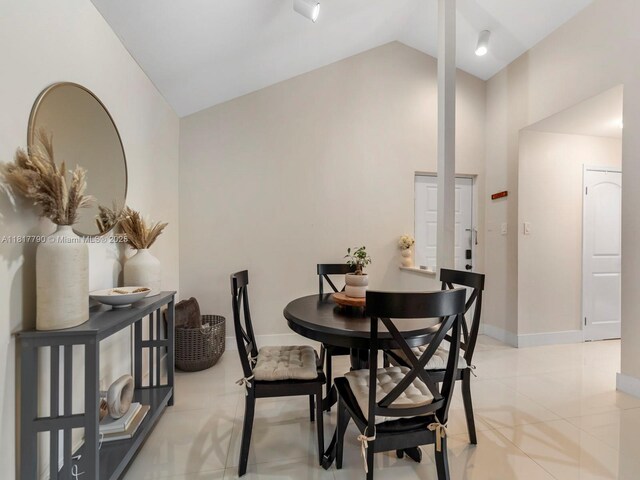 10421 SW 157th Pl Unit 301, Miami, FL 33196 - dining area featuring lofted ceiling, light tile patterned flooring, and baseboards