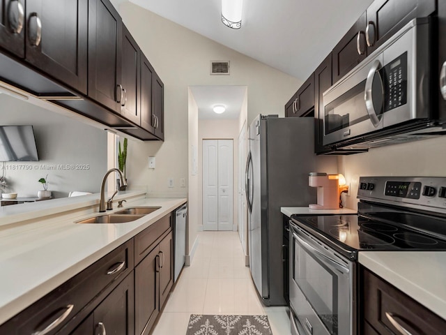 10421 SW 157th Pl Unit 301, Miami, FL 33196 - kitchen with appliances with stainless steel finishes, a sink, lofted ceiling, light countertops, and light tile patterned flooring
