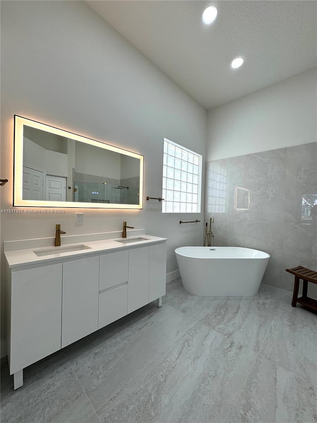 7020 Demedici Cir, Delray Beach, FL 33446 - bathroom with double vanity, a freestanding bath, a walk in shower, and recessed lighting