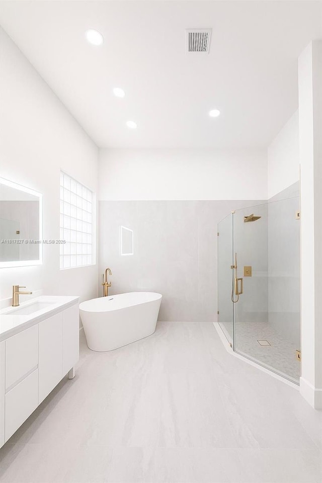 7020 Demedici Cir, Delray Beach, FL 33446 - bathroom with vanity, a shower stall, a freestanding tub, and recessed lighting